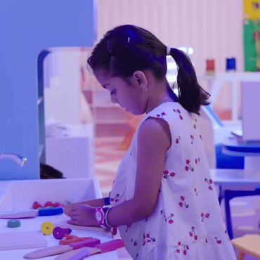 Child enjoying a hands-on creative play activity at Wooray Hyderabad indoor play area.