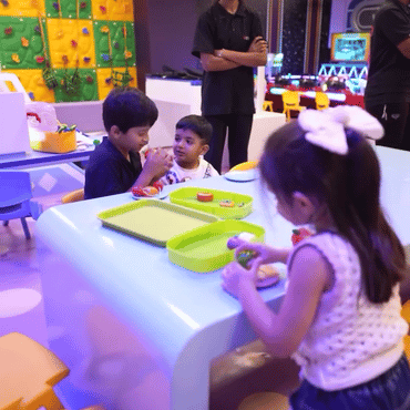 Children enjoying a group creative play activity together at Wooray Hyderabad.