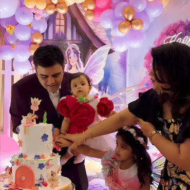 Family celebrating a child's birthday with a decorated cake at Wooray Hyderabad.