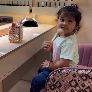 Child sitting in the dining area and enjoying a treat at Wooray Hyderabad.